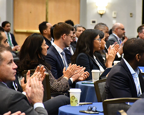 People applaud while seated at tables at the 2025 MWBE Conference.